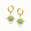 Gold hoop earrings with sunburst designs and blue gemstones.