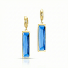 Gold earrings with blue rectangular stones on a white background