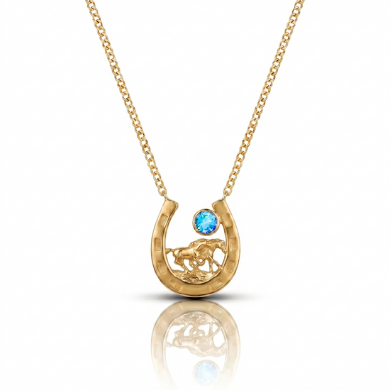 Gold necklace with a horseshoe pendant featuring a blue gemstone on a white background