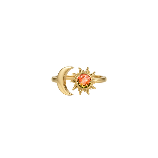 Gold ring with sun and moon design on a white background