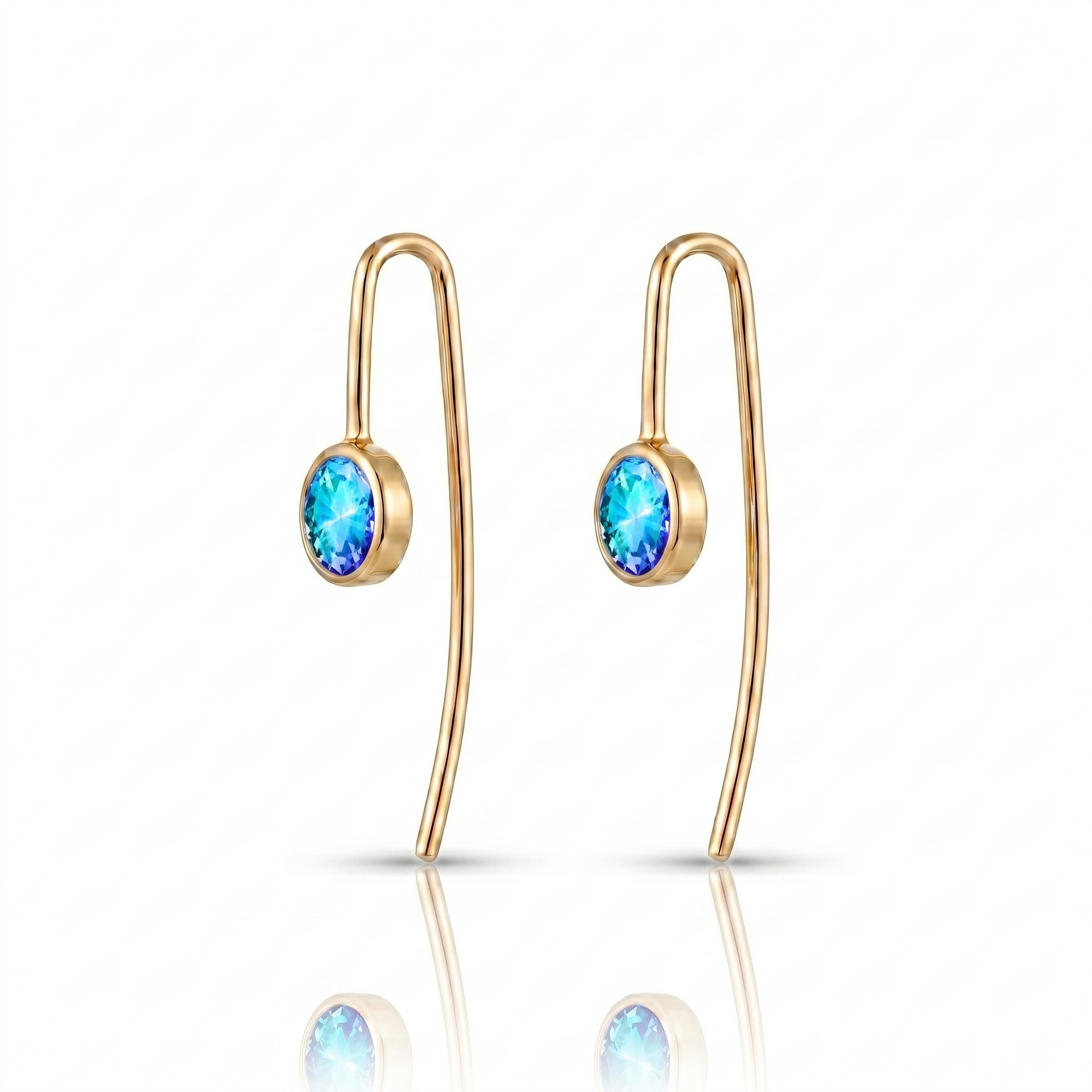 Gold earrings with blue gemstones on a white background