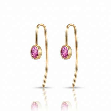 Gold earrings with pink gemstones on a white background