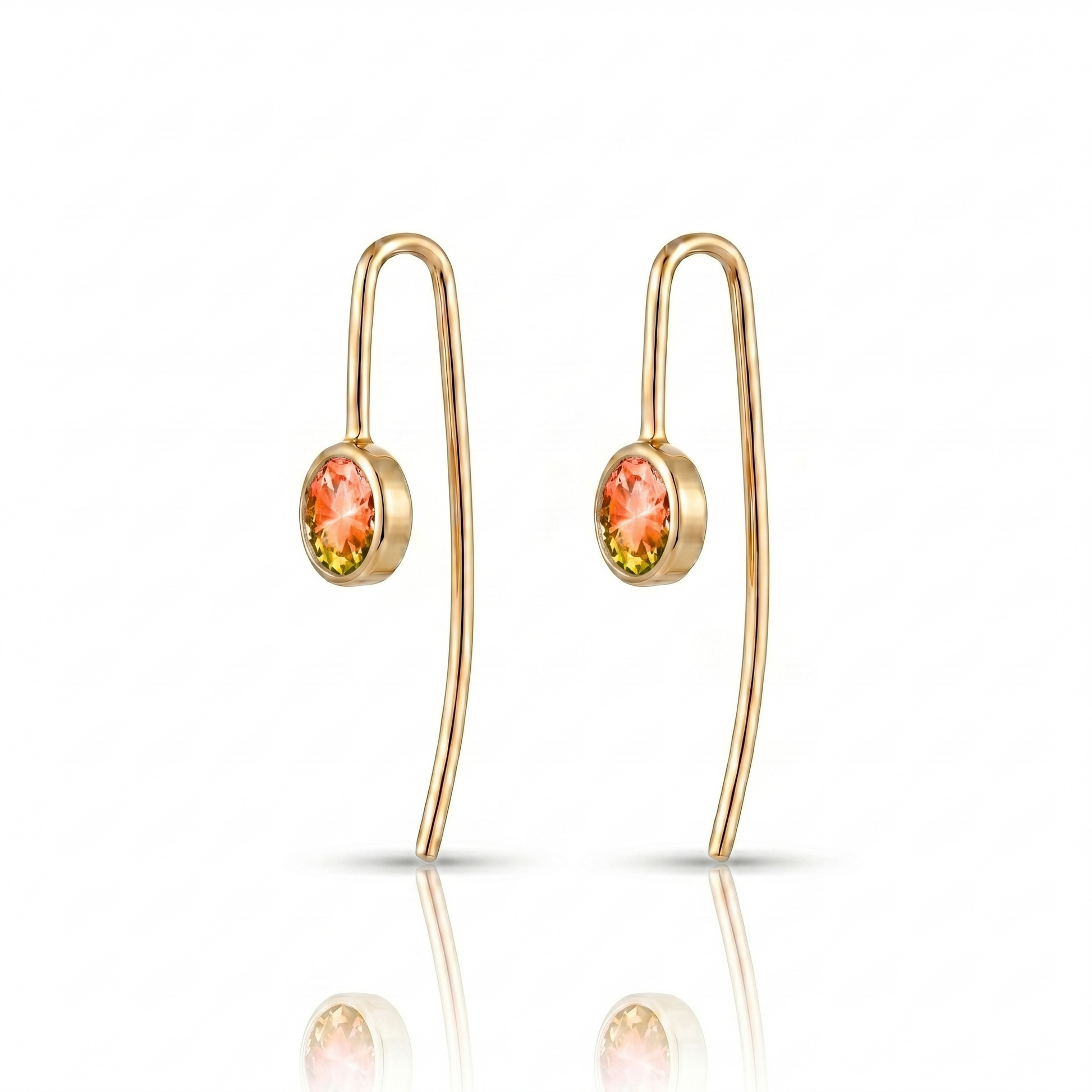 Gold earrings with colorful gemstones on a white background