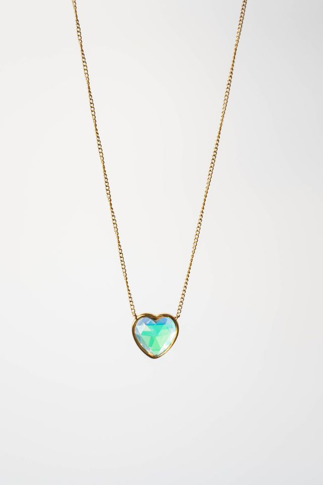 Heart-shaped opal pendant on a gold chain against a white background