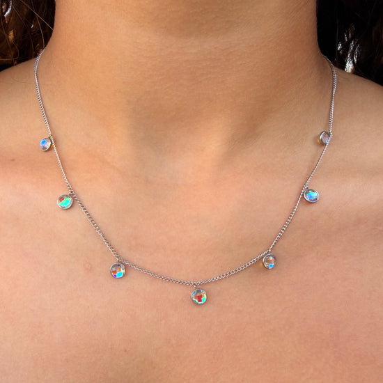 Station Necklace with colorful gemstones on a person's neck