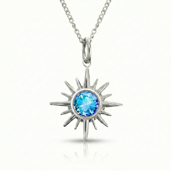 Silver sun-shaped pendant with a blue gemstone.