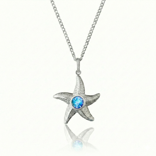 Starfish-shaped pendant with a blue gemstone on a chain