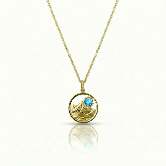 Gold featuring a minimalist mountain silhouette pendant on a delicate gold chain