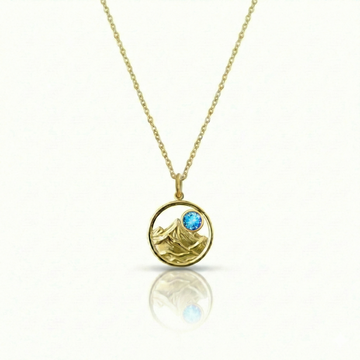 Gold featuring a minimalist mountain silhouette pendant on a delicate gold chain