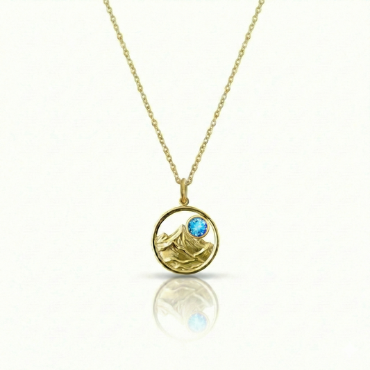 Gold featuring a minimalist mountain silhouette pendant on a delicate gold chain
