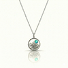 Silver necklace with a mountain pendant and a blue gemstone.