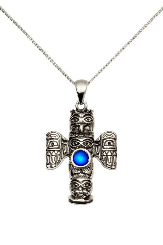 Necklace in gold featuring a symbolic engraved totem design accented with frosted blue gemstone on a delicate chain