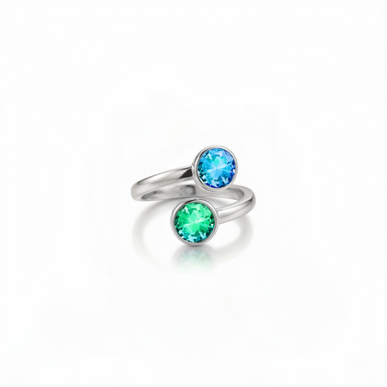 Silver ring with blue and green gemstones on a white background