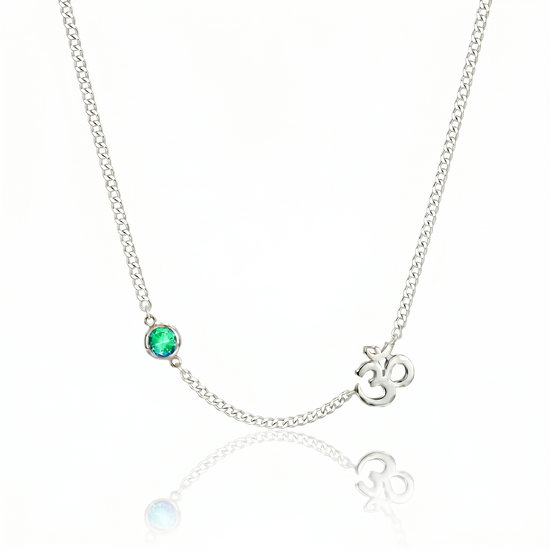 Necklace with emerald stone and Om symbol on a white background