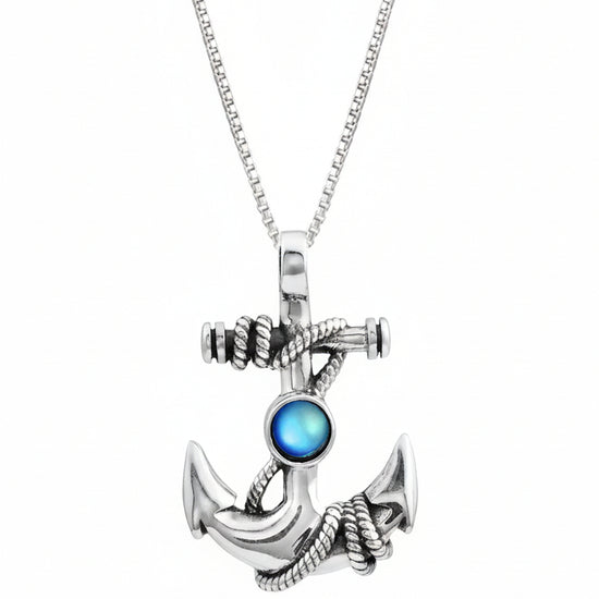 Silver anchor pendant with a blue gemstone on a white background