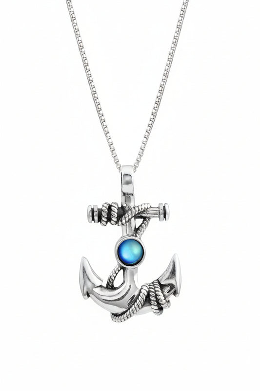 Silver anchor pendant with a blue gemstone on a white background