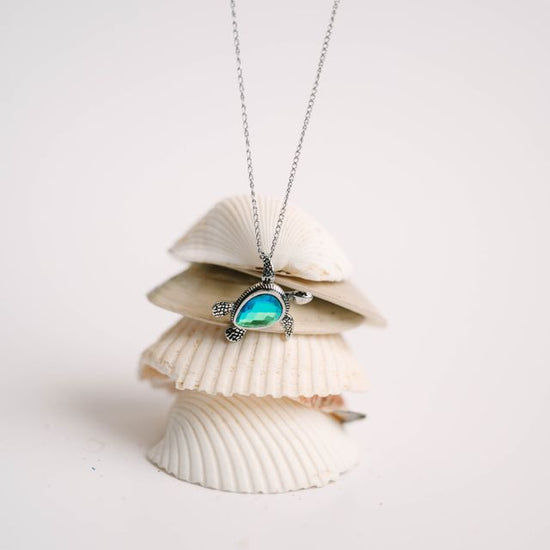 This adorable baby turtle pendant is available in shimmering blue or green, with your choice of stainless steel or 18K gold over stainless. The head, arms, and legs move, adding playful character to this instant favorite. Designed for everyday wear—whether you're at work, in the ocean, or off on your next adventure. 