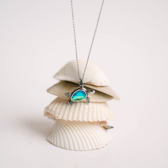 This adorable baby turtle pendant is available in shimmering blue or green, with your choice of stainless steel or 18K gold over stainless. The head, arms, and legs move, adding playful character to this instant favorite. Designed for everyday wear—whether you're at work, in the ocean, or off on your next adventure. 