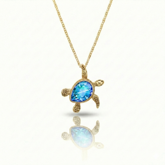 Baby Turtle pendant in shimmering blue stone with 18k gold. Comes with a 1mm adjustable 16–18" chain.