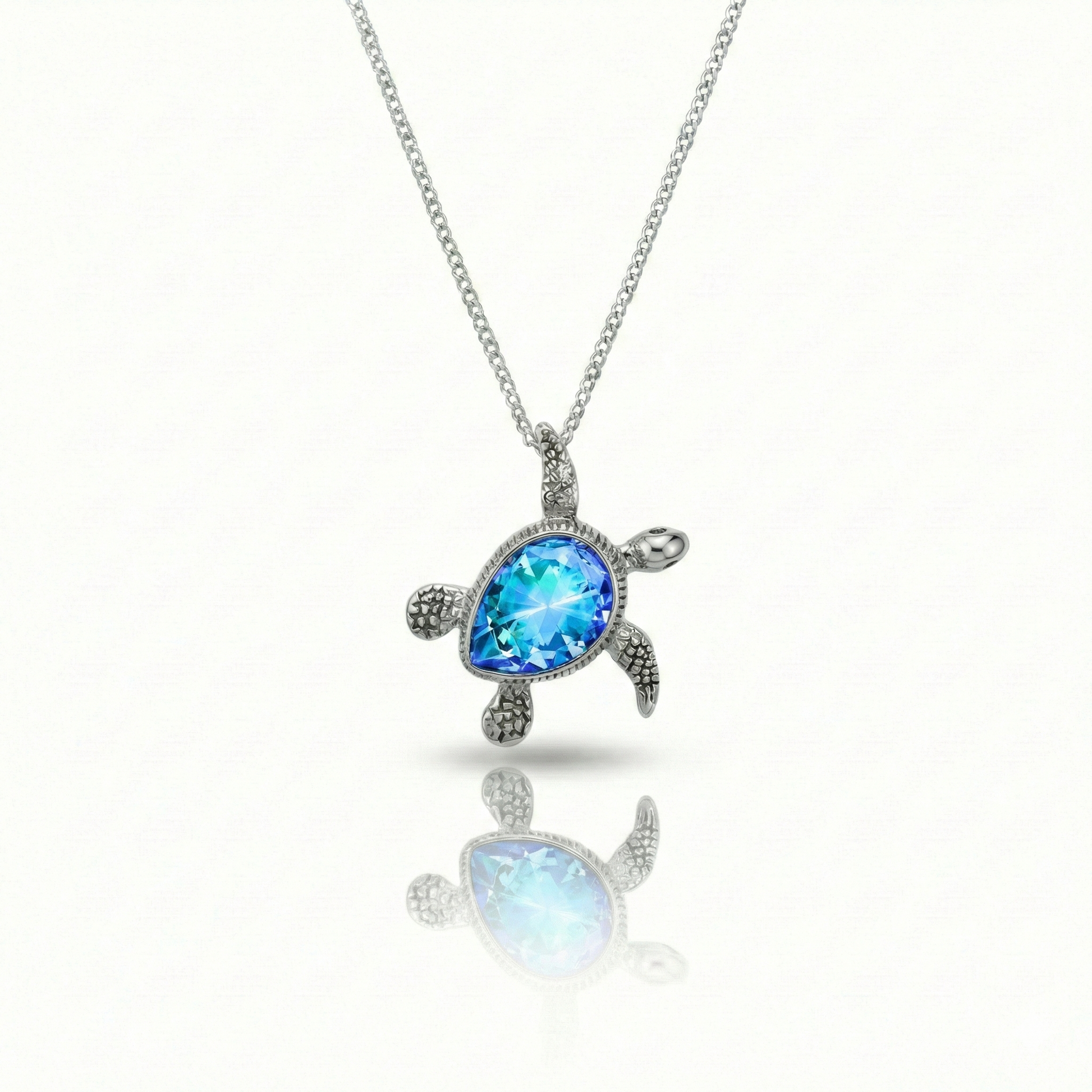 Baby Turtle pendant in shimmering blue stone with stainless steel. Comes with a 1mm adjustable 16–18" chain.