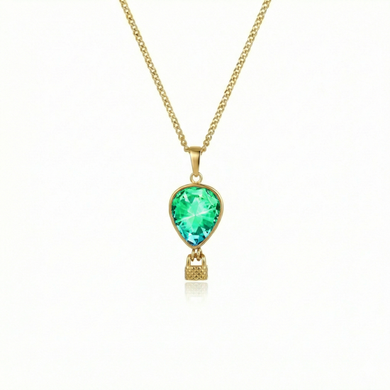 Gold necklace with a green pendant featuring a delicate hot air balloon charm on a fine chain