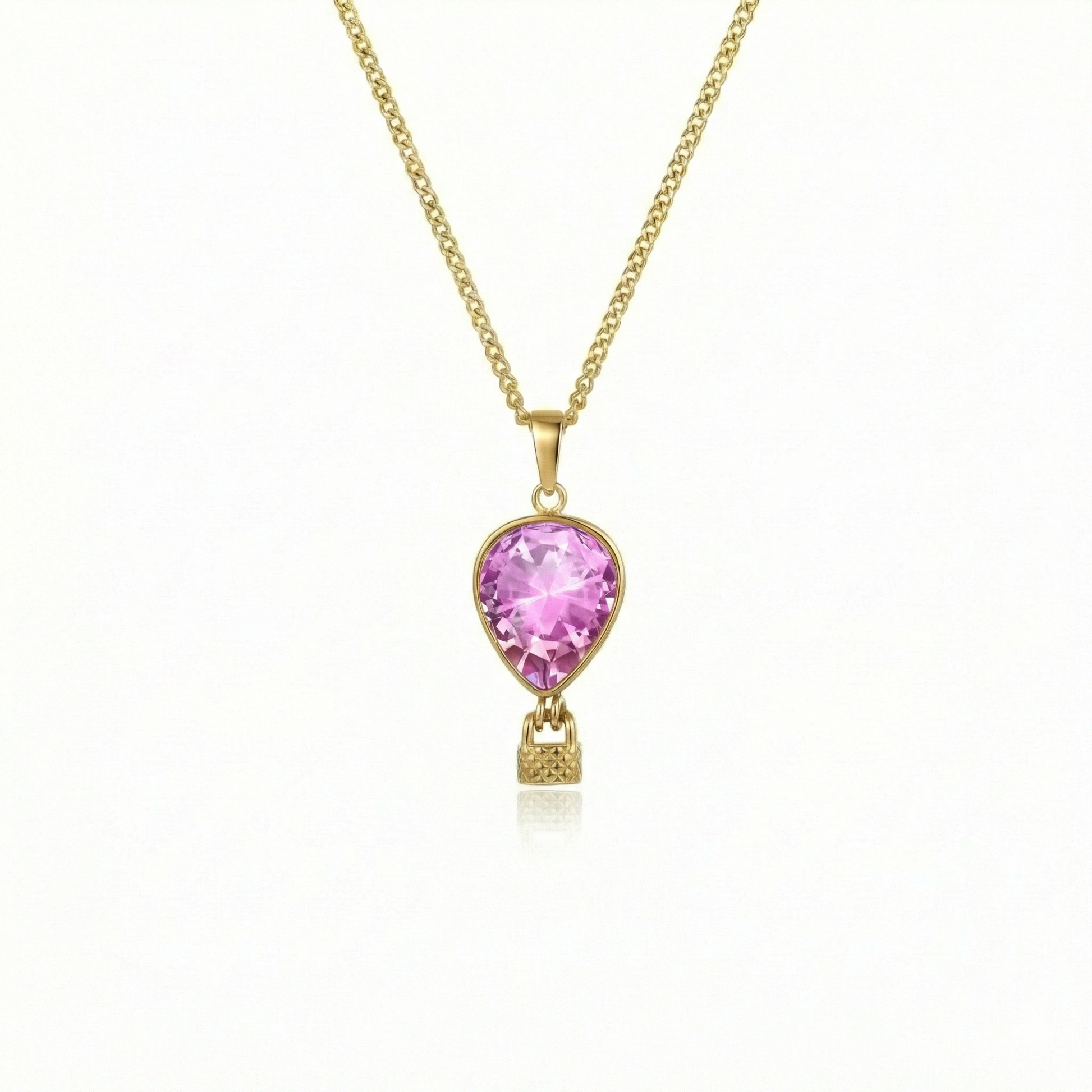 Gold necklace with a pink pendant featuring a delicate hot air balloon charm on a fine chain.