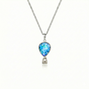 Silver necklace with a blue pendant featuring a delicate hot air balloon charm on a fine chain.