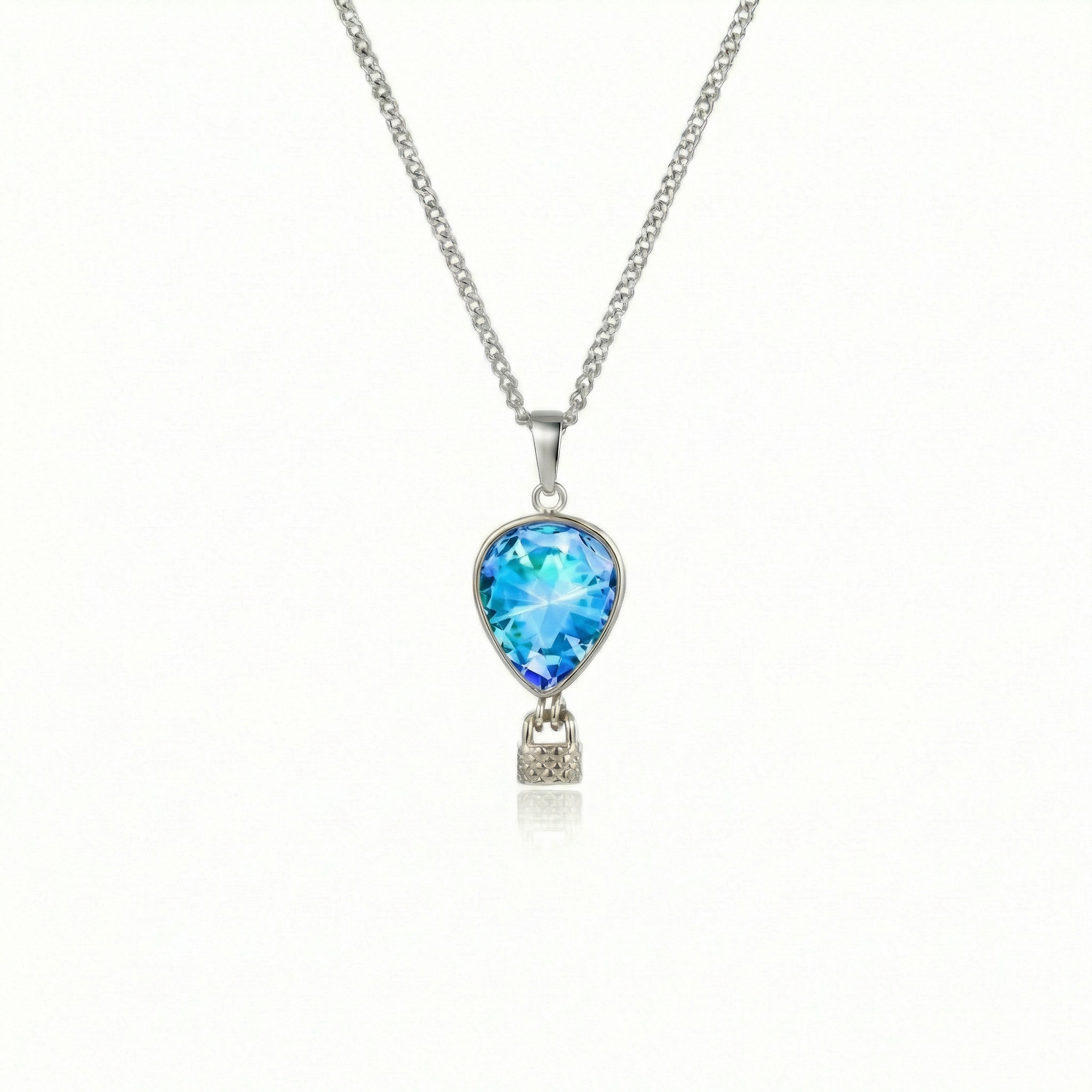 Silver necklace with a blue pendant featuring a delicate hot air balloon charm on a fine chain.