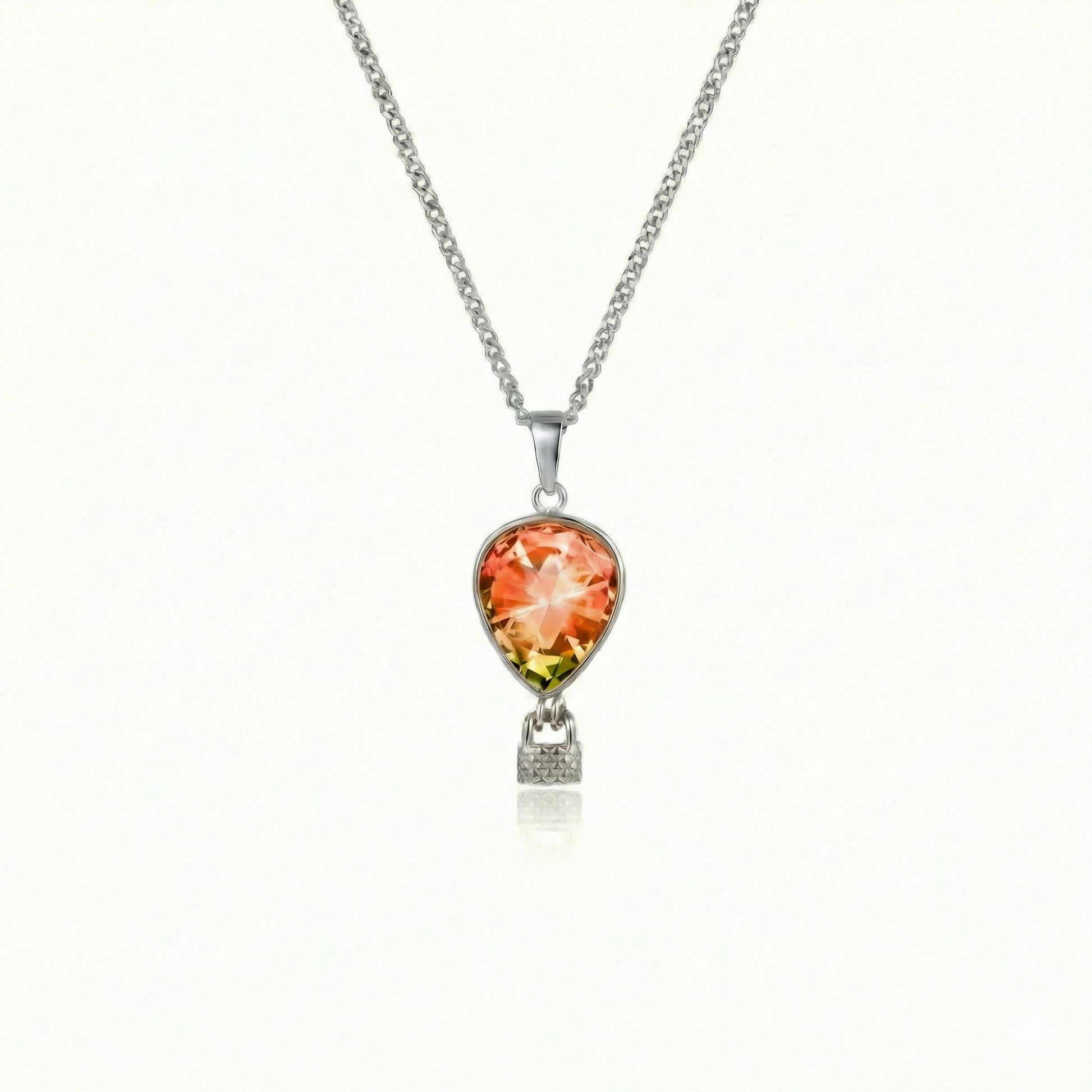 Silver necklace with a fire pendant featuring a delicate hot air balloon charm on a fine chain.