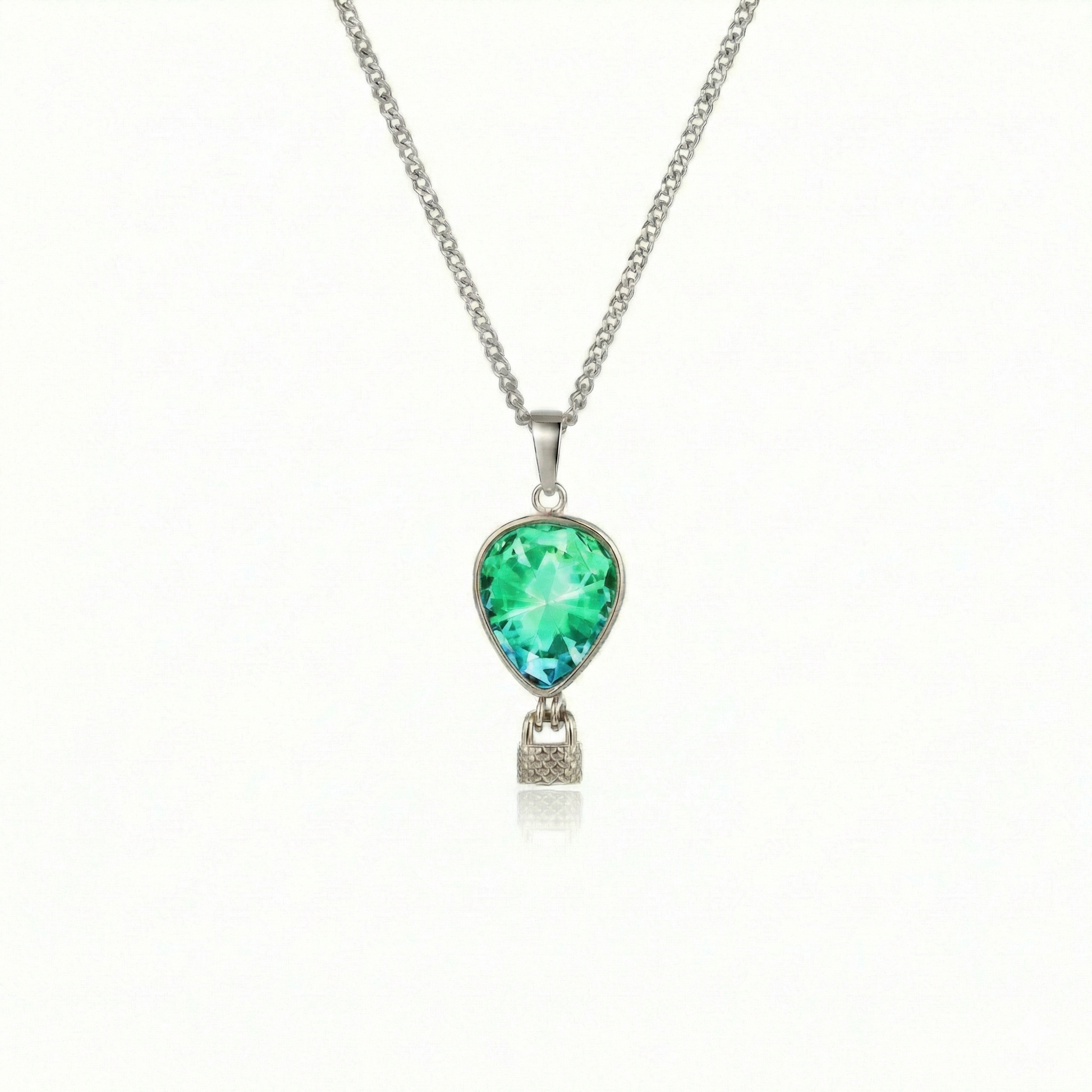 Silver necklace with a green pendant featuring a delicate hot air balloon charm on a fine chain.