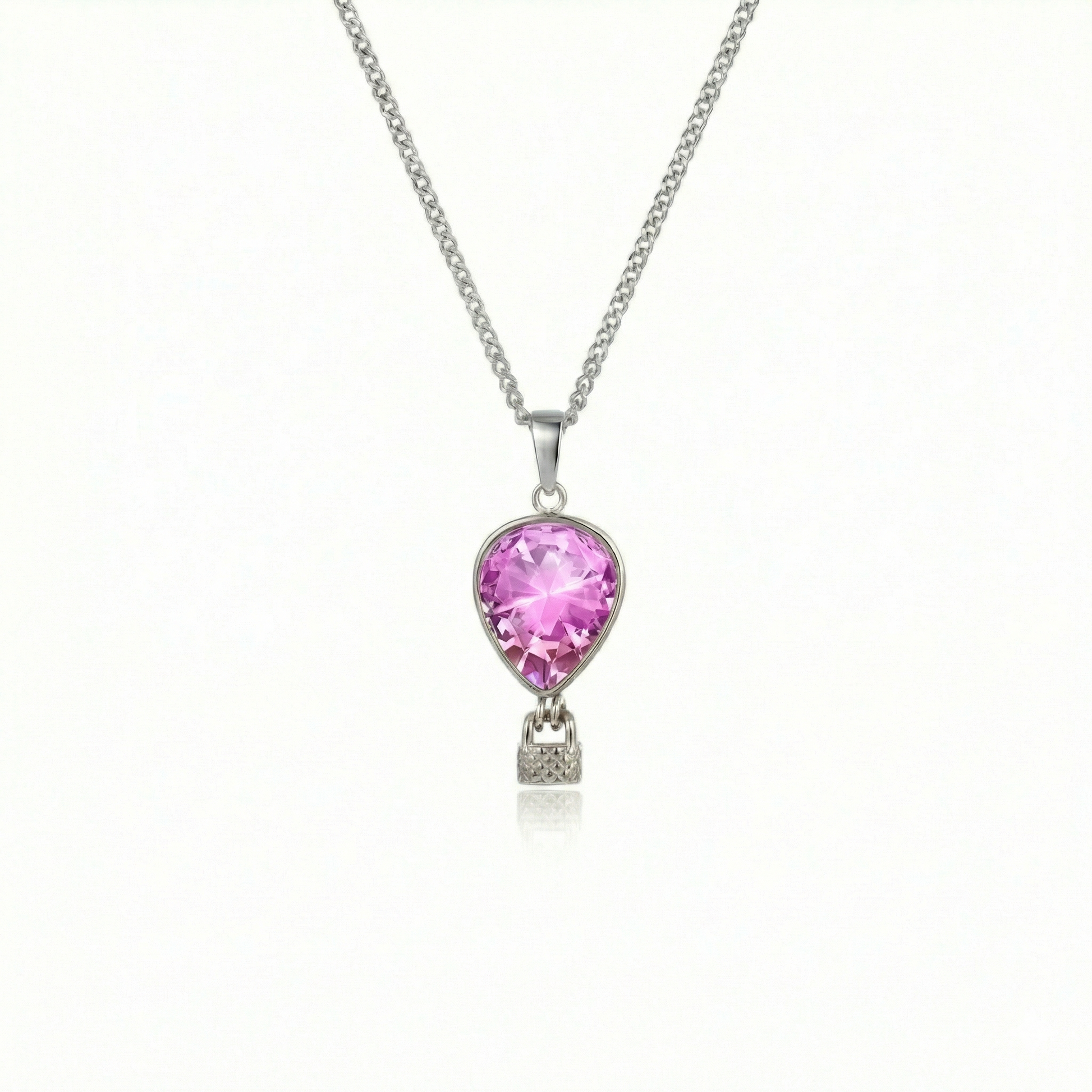 Silver necklace with a pink pendant featuring a delicate hot air balloon charm on a fine chain.