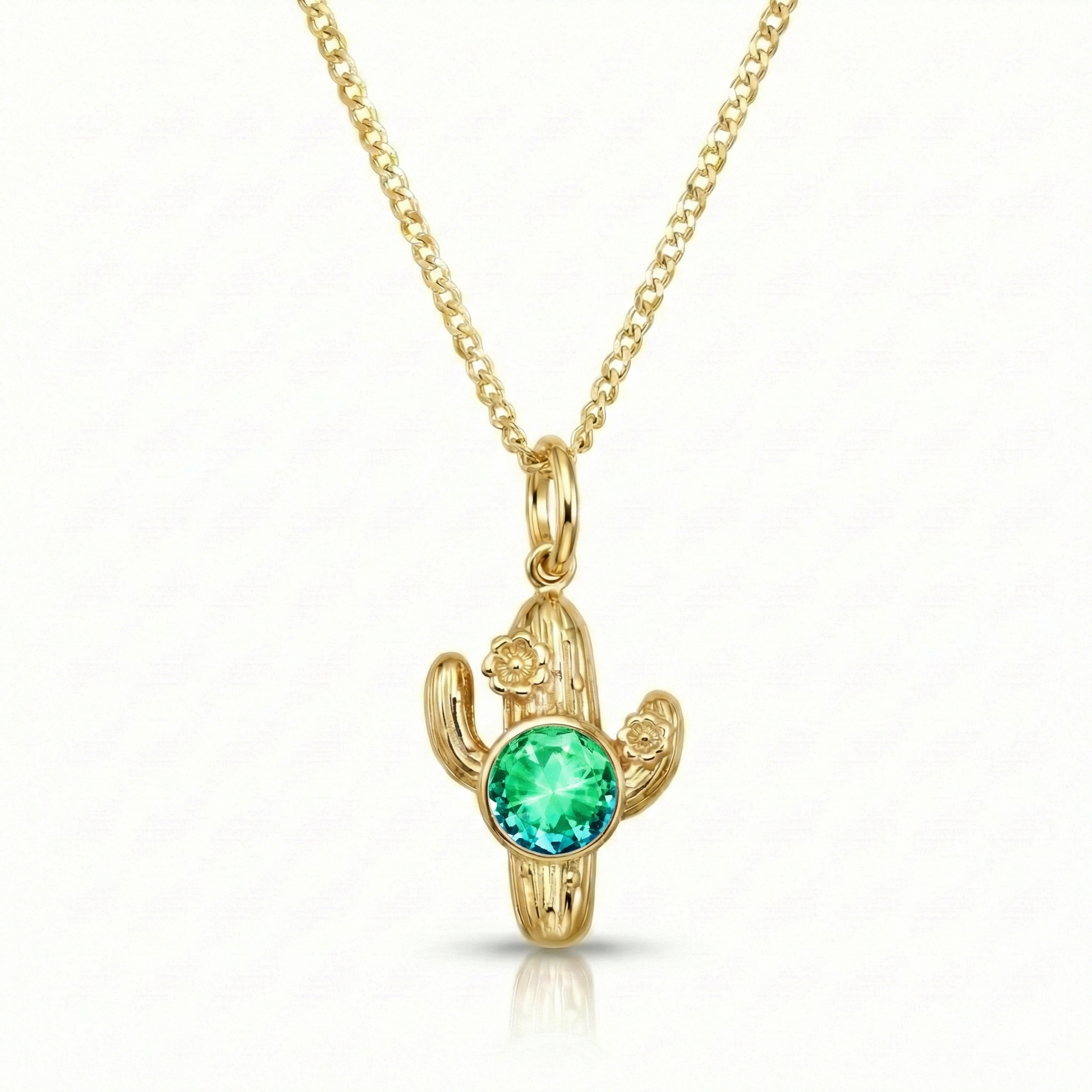 Gold cactus-shaped pendant with a green gemston