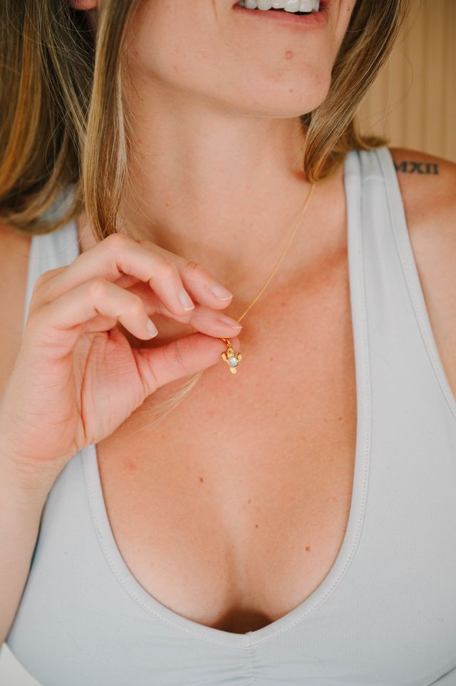 Cactus Pendant, a charming accessory that brings a touch of desert mystery and resilience to your wardrobe. Whether you're dressing up for a special occasion or accentuating your everyday look, this pendant adds a unique flair that is both elegant and playful. 