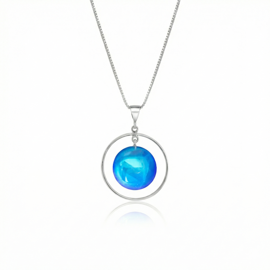 Circle with Loop Pendant featuring a simple round crystal beautifully encircled by a .925 sterling silver loop. The polished blue pendant comes with an 18" sterling silver .7mm box chain included.