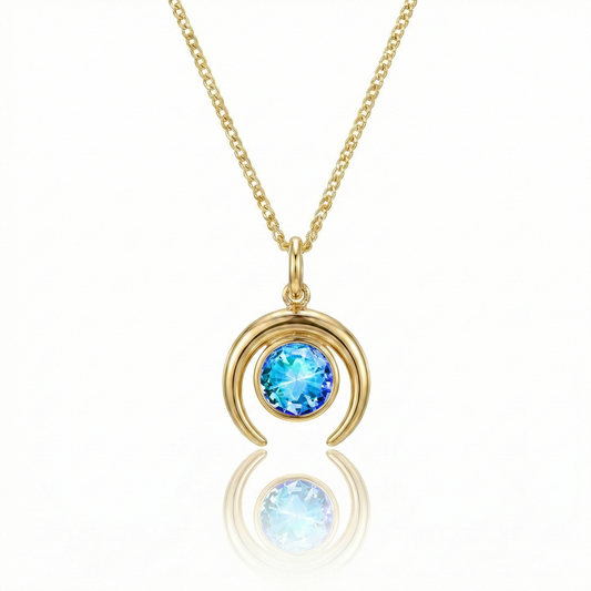 Gold crescent necklace with a blue gemstone pendant.