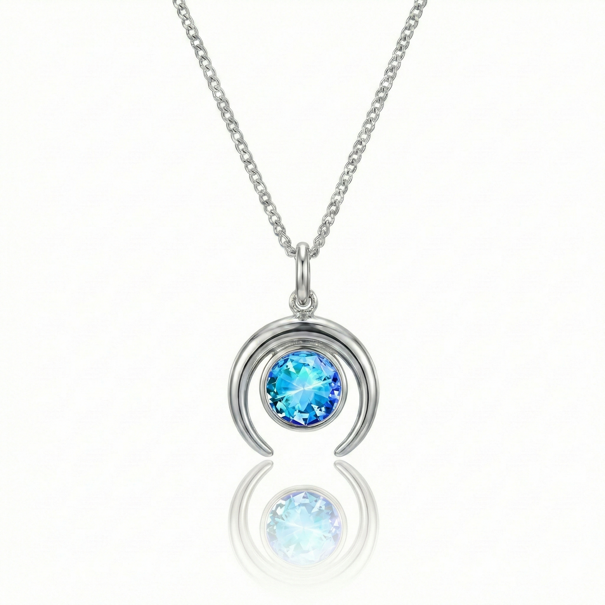 Silver crescent necklace with a blue gemstone pendant.