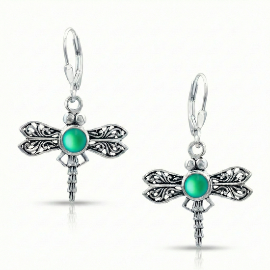 Sterling Silver Dragonfly Earrings feature a frosted green glowing crystal delicately surrounded by intricate silver details in the wings and body of the dragonfly, creating a whimsical yet elegant look.