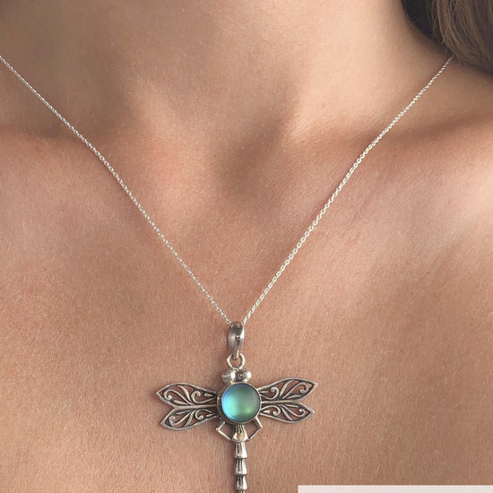 Dragonfly Pendant, this handmade pendant features a stunning glowing frosted green crystal, elegantly surrounded by intricate silver details in the dragonfly's wings and body. The pendant comes with an 18" sterling silver .7mm box chain included.