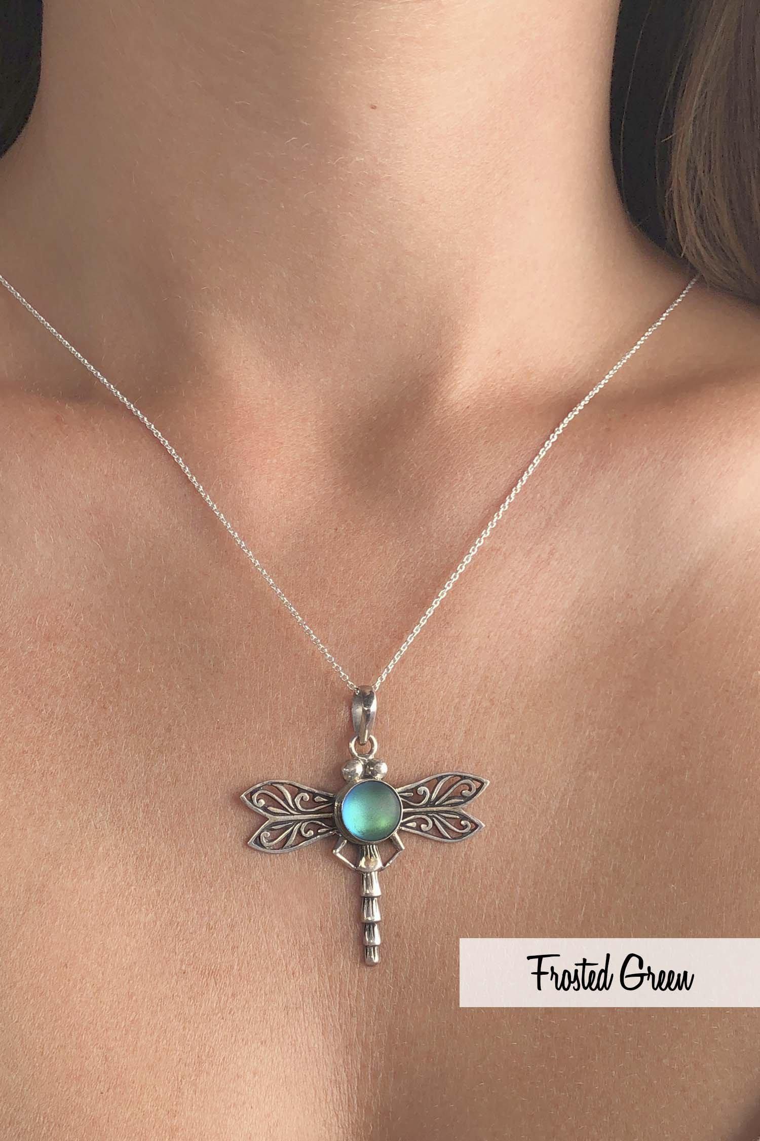Dragonfly Pendant, this handmade pendant features a stunning glowing frosted green crystal, elegantly surrounded by intricate silver details in the dragonfly's wings and body. The pendant comes with an 18" sterling silver .7mm box chain included.