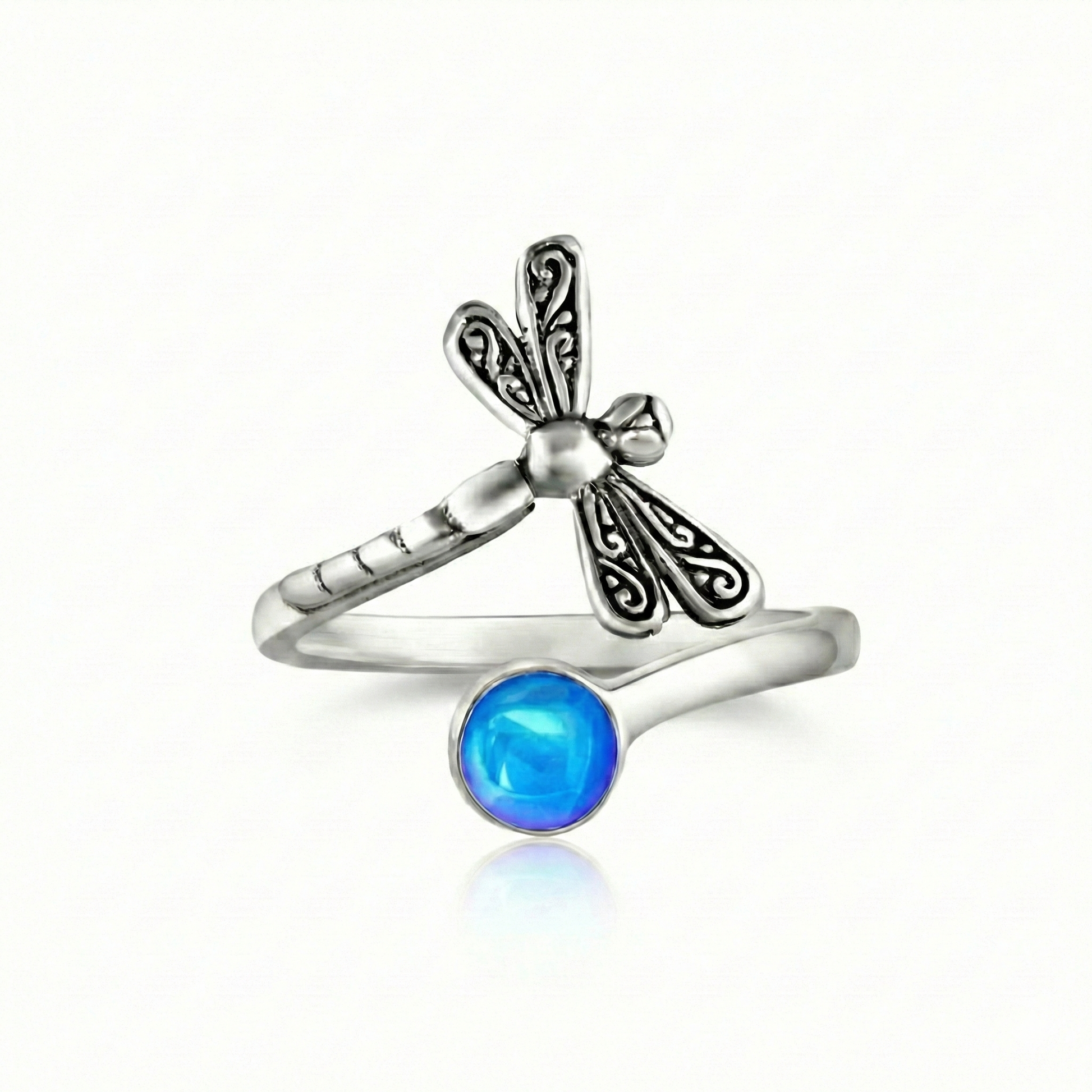 Dragonfly Ring, this adjustable handmade ring features a stunning glowing 5mm polished blue crystal, elegantly surrounded by intricate silver details in the wings and body of the dragonfly.