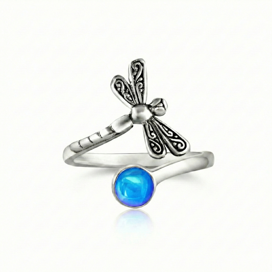 Dragonfly Ring, this adjustable handmade ring features a stunning glowing 5mm polished blue crystal, elegantly surrounded by intricate silver details in the wings and body of the dragonfly.