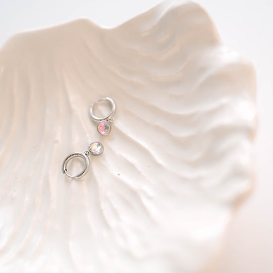 Perfectly sized with a 9mm circle, these earrings are crafted to add a subtle yet striking touch of sophistication to your everyday ensemble. Inspired by the celestial beauty of an eclipse, the minimalist design highlights a radiant crystal that catches the light with every move.
