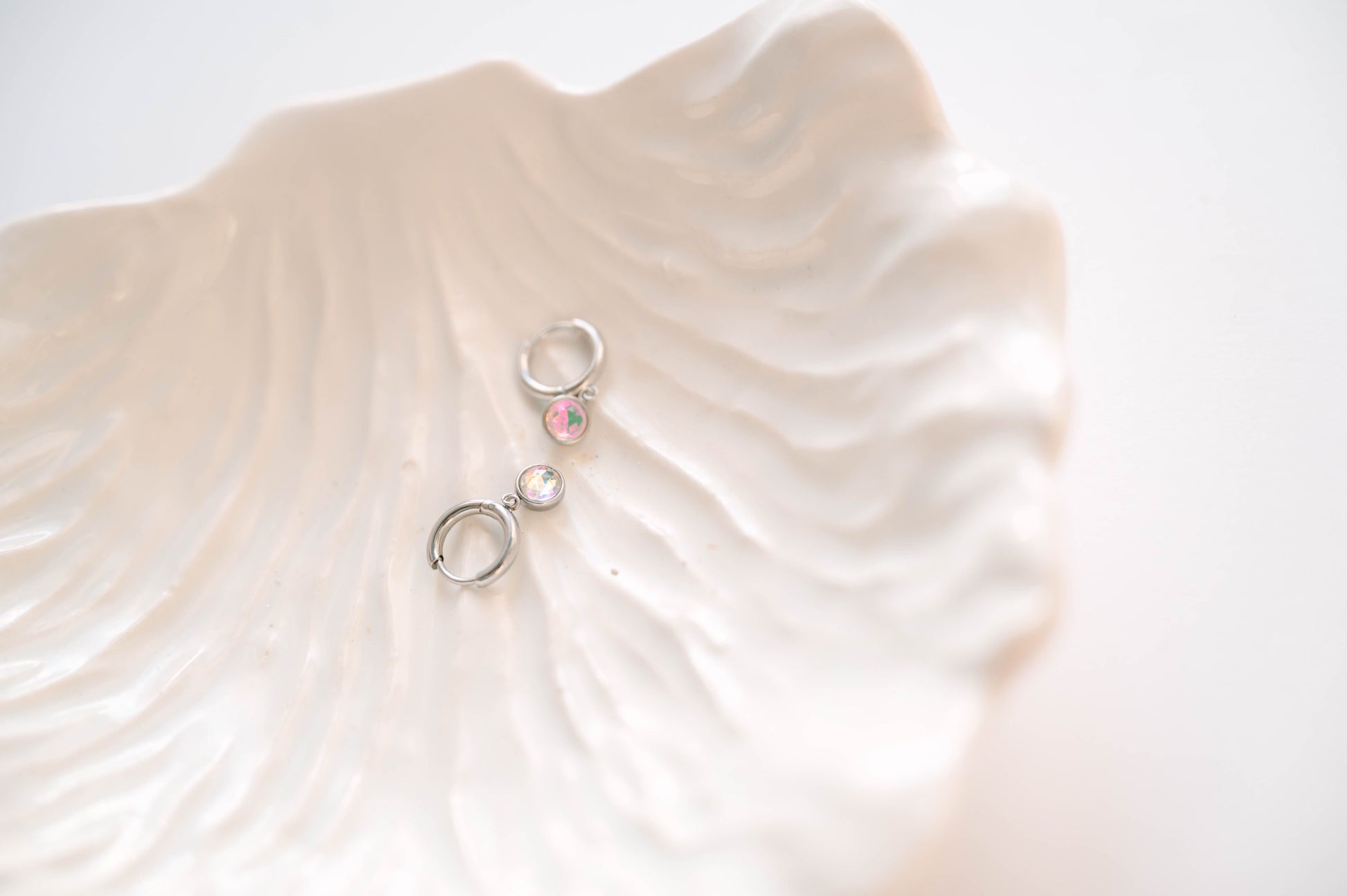 Perfectly sized with a 9mm circle, these earrings are crafted to add a subtle yet striking touch of sophistication to your everyday ensemble. Inspired by the celestial beauty of an eclipse, the minimalist design highlights a radiant crystal that catches the light with every move.
