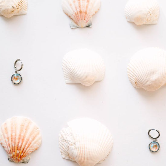  Perfectly sized with a 9mm circle, these earrings are crafted to add a subtle yet striking touch of sophistication to your everyday ensemble. Inspired by the celestial beauty of an eclipse, the minimalist design highlights a radiant crystal that catches the light with every move.