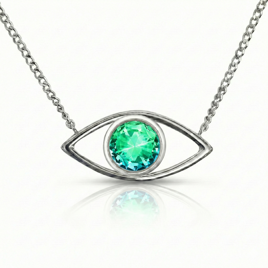 Silver necklace with a green gemstone eye pendant.