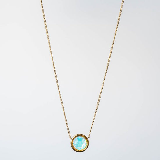 This exquisite necklace showcases a dazzling 9mm crystal, designed to capture and reflect light from every angle, ensuring you shine with every step you take.