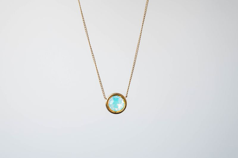 This exquisite necklace showcases a dazzling 9mm crystal, designed to capture and reflect light from every angle, ensuring you shine with every step you take.