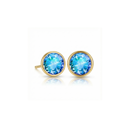 Gold earrings with blue gemstones on a white background