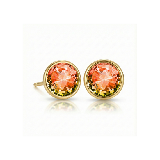 Gold earrings with fire gemstones on a white background