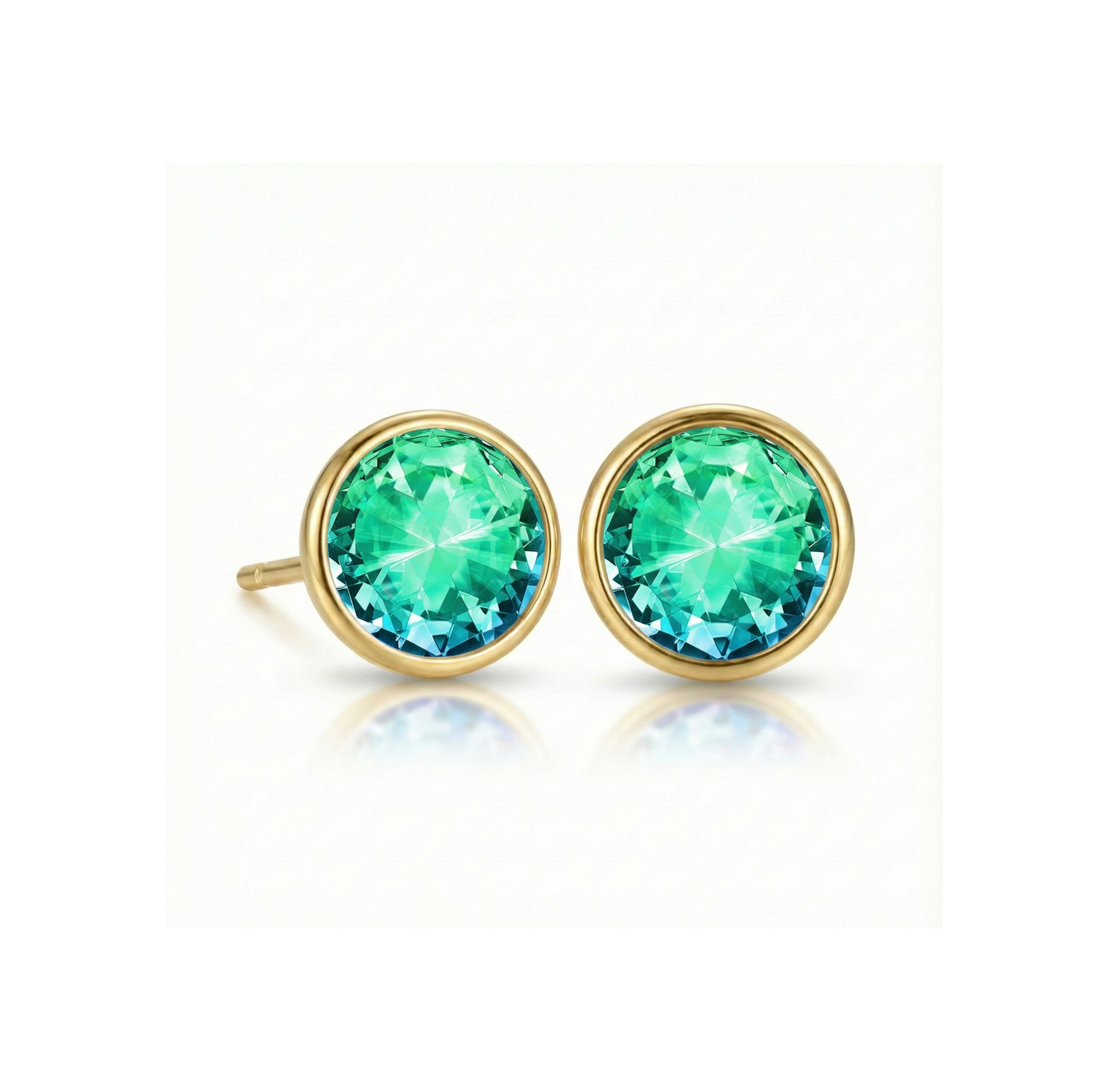 Gold earrings with green gemstones on a white background
